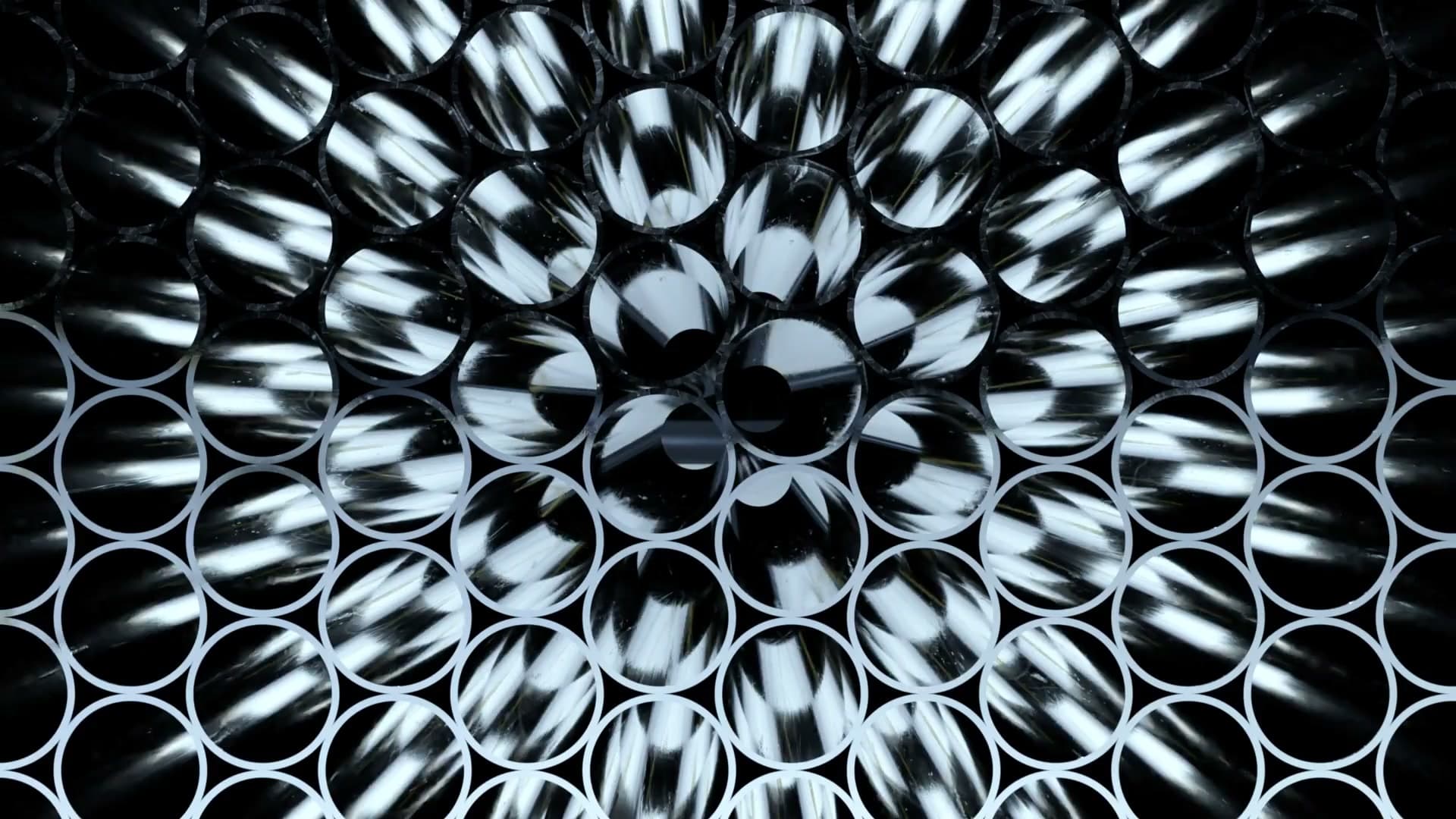 Stacked steel tubes seen end-on, filling the frame
